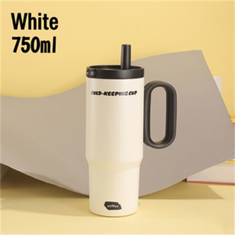 Cream white 26oz insulated coffee tumbler with black handle and straw.