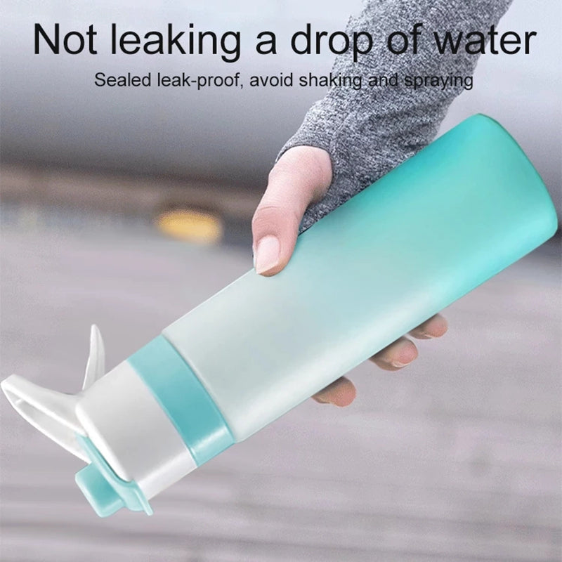 Woman spraying mist from water bottle to cool down during outdoor workout